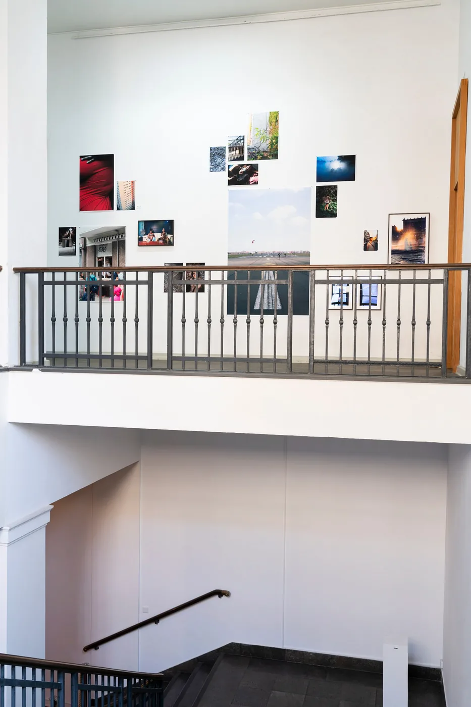 Installation view: photographs hung across a stairwell wall at the Museum für Fotografie.
